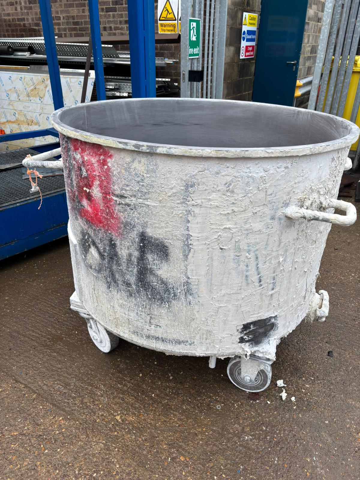 Industrial container with heavy paint buildup and surface contamination