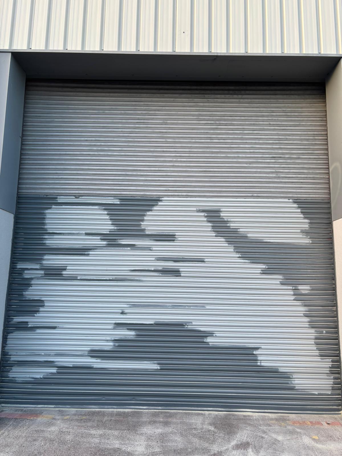 Roller shutter slats with severe rust staining and paint degradation