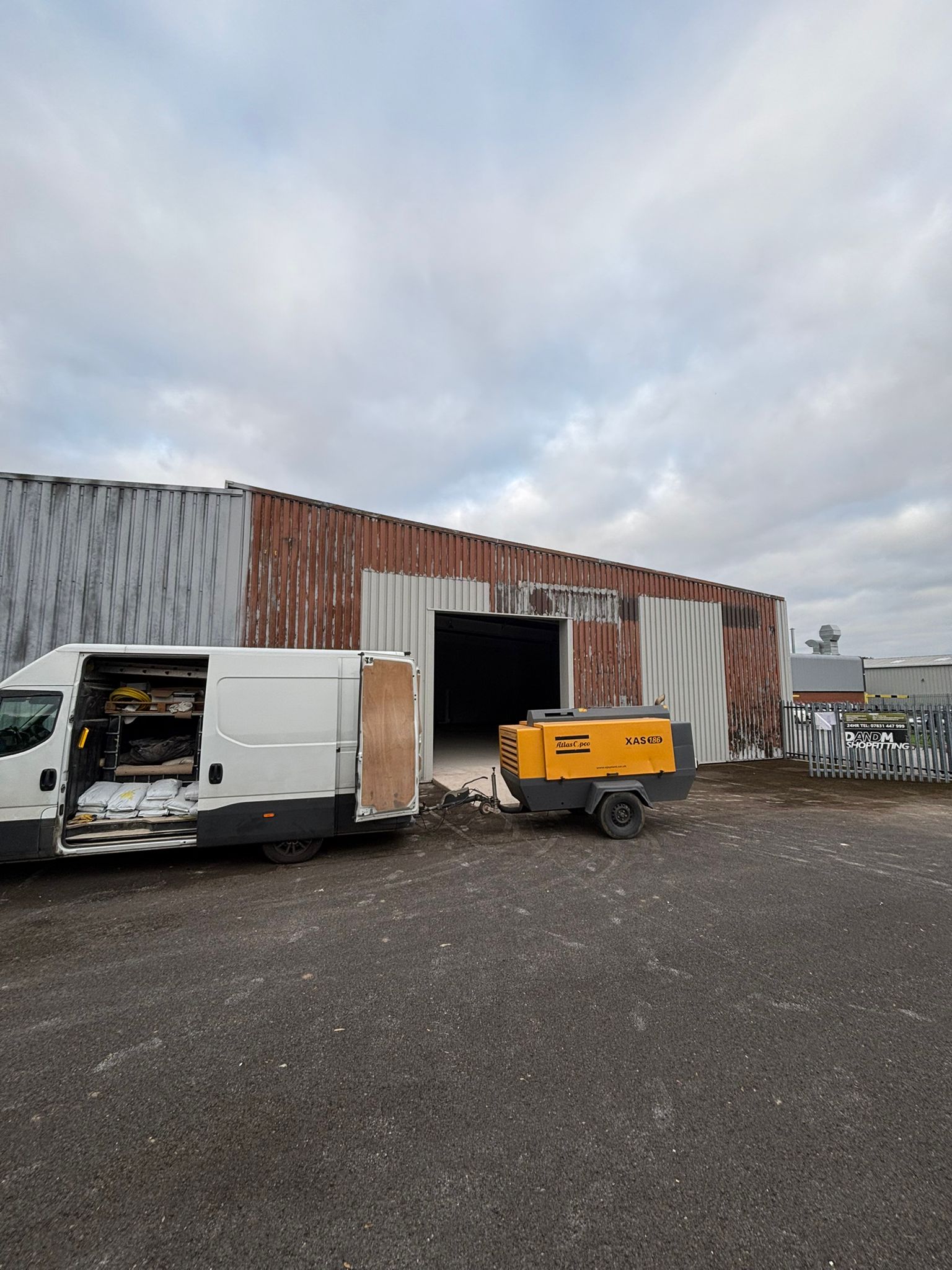 Warehouse exterior showing deteriorated cladding