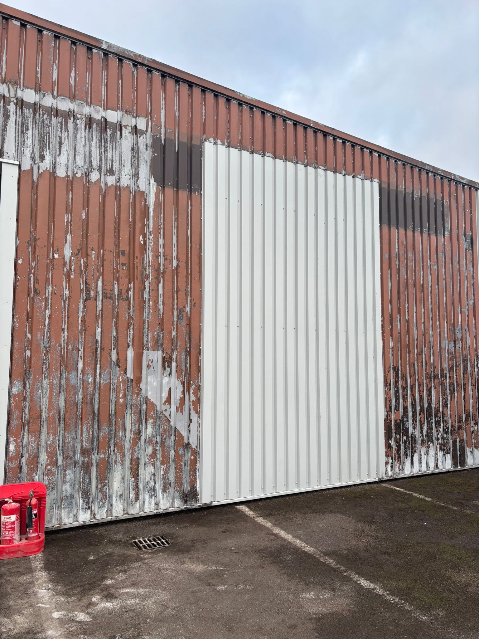 Cladding showing multiple paint layers and rust