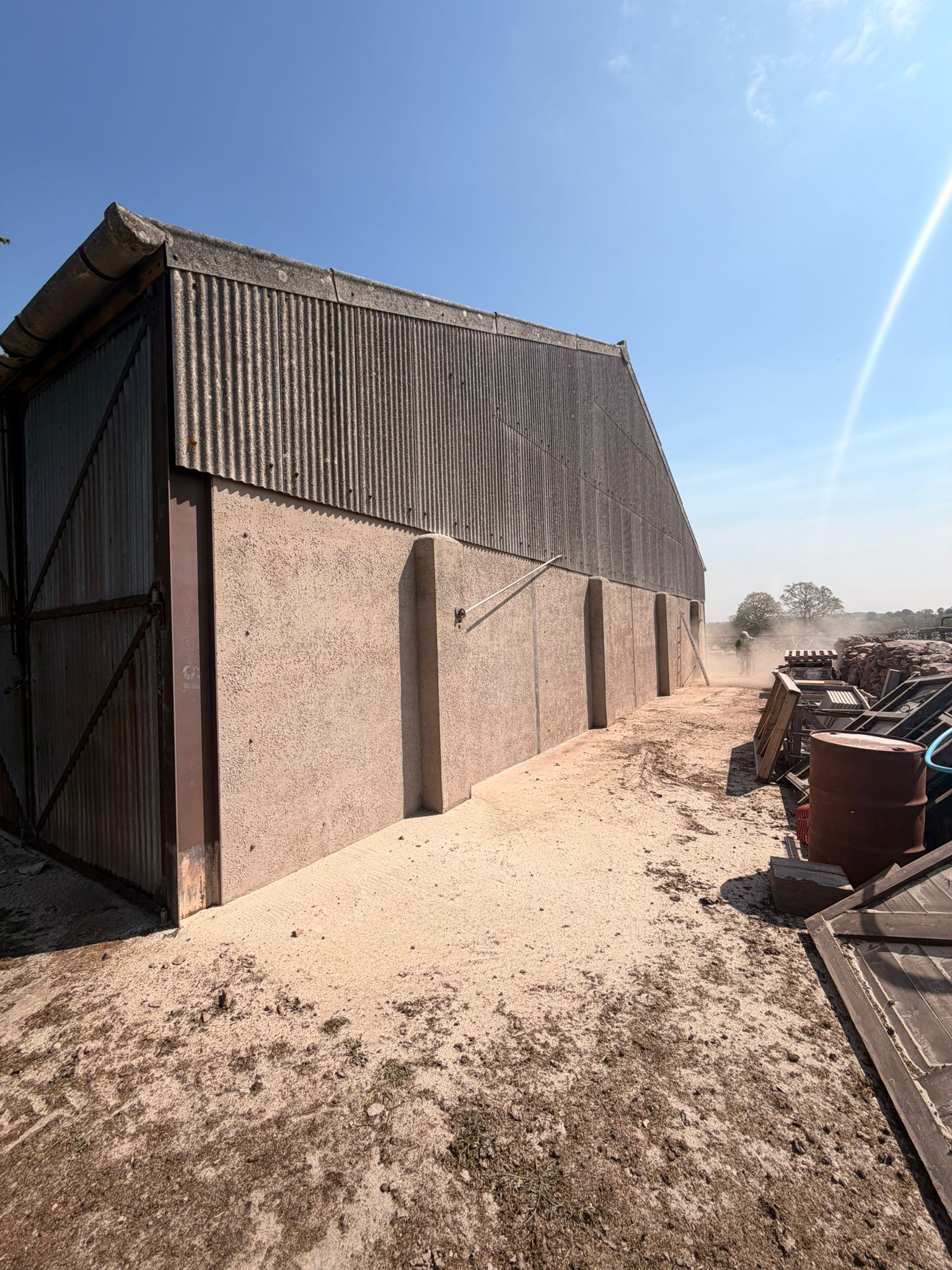 Agricultural building end gable after shot blasting — corrugated steel and concrete