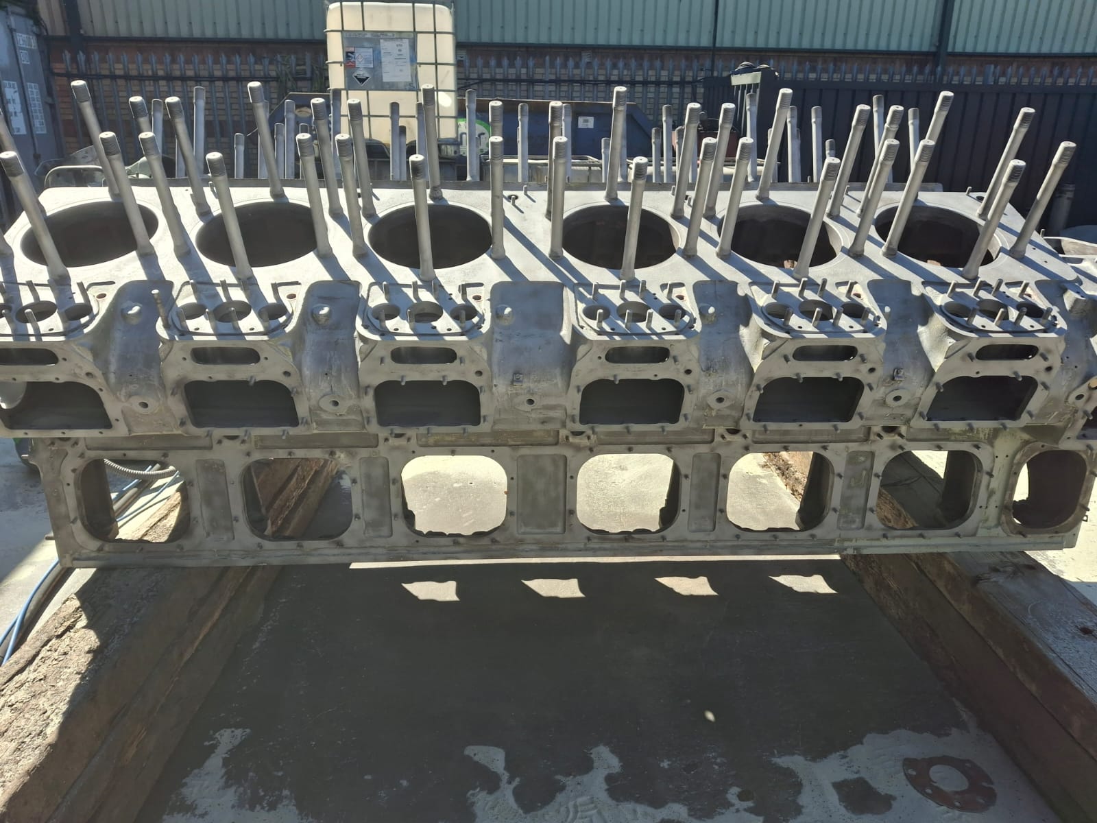 Marine engine block after shot blasting — clean bare metal side view